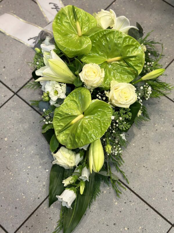 Funeral arrangement of white roses, lilys and anthuriums