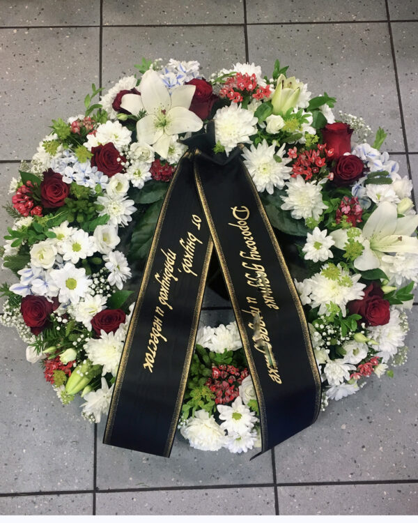 Funeral wreath: mix of red and white blooms