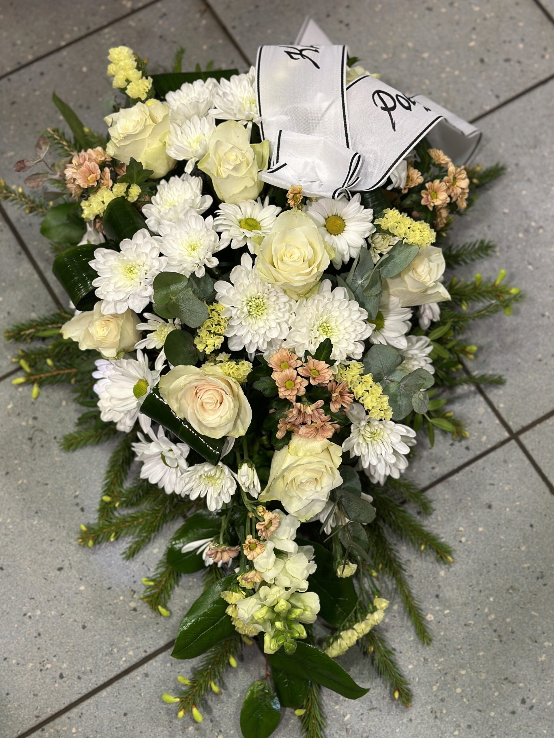 Funeral arangement: white roses, white and yellow chrysantemums
