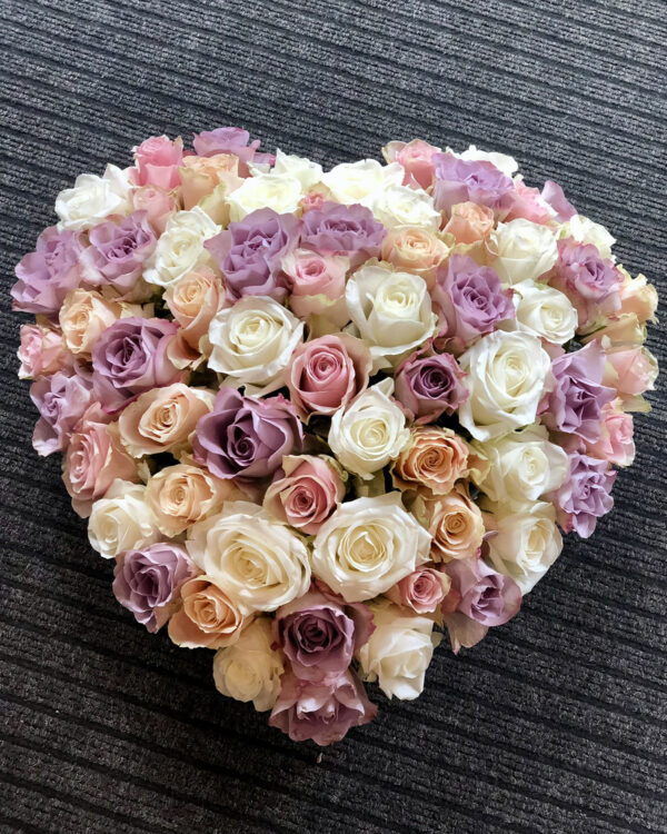 Heart-shaped arrangement of pastel roses